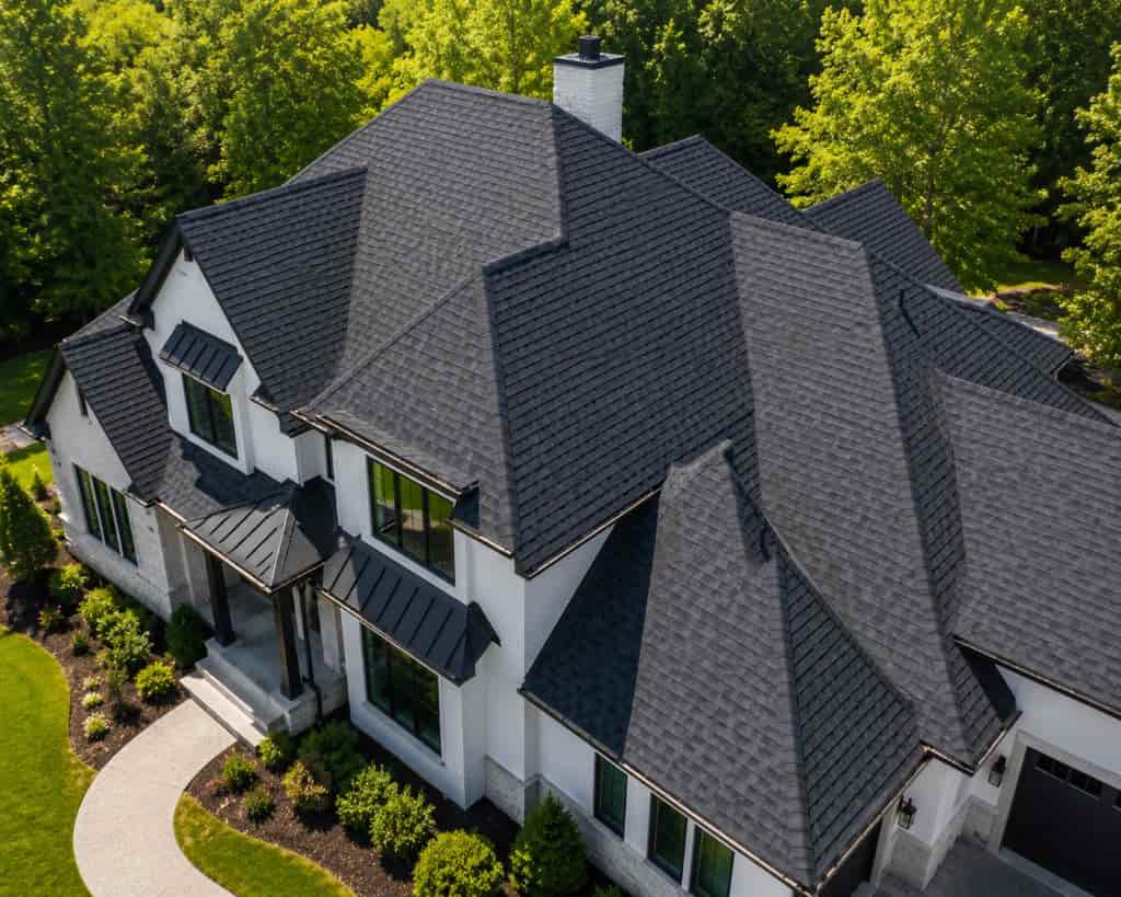 Completed dark charcoal architectural shingle roof on a luxury home by SCR, Inc. General Contractors in Ponder, TX.