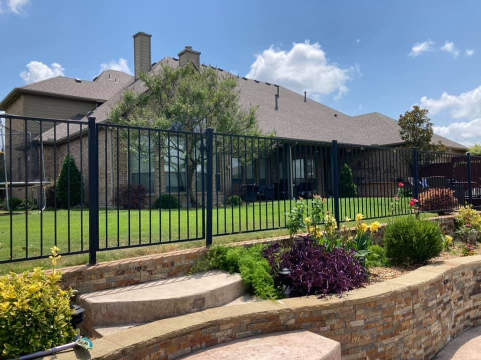 Residential home with a well-maintained shingle roof and landscaped backyard