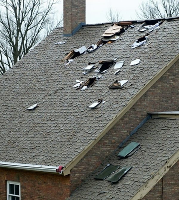 Roofer documenting storm and hail damage for an insurance claim in Ennis, TX.