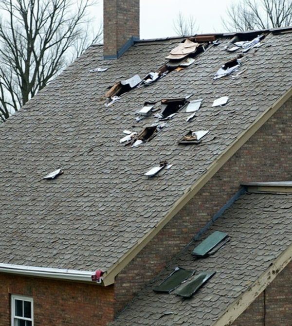 Roofer documenting storm and hail damage for an insurance claim in Ennis, TX.