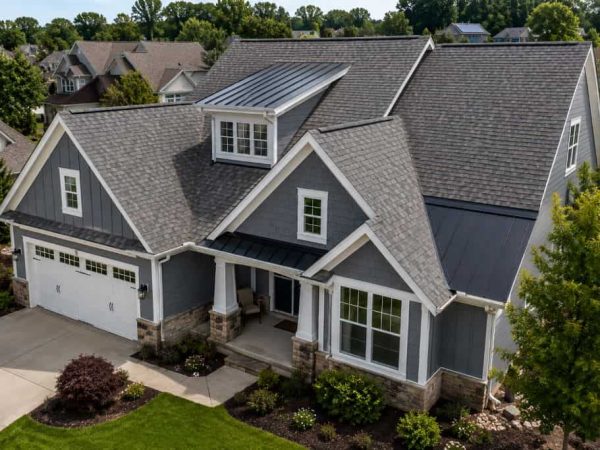 Residential home with architectural shingles and metal roof accents in Saginaw, TX.